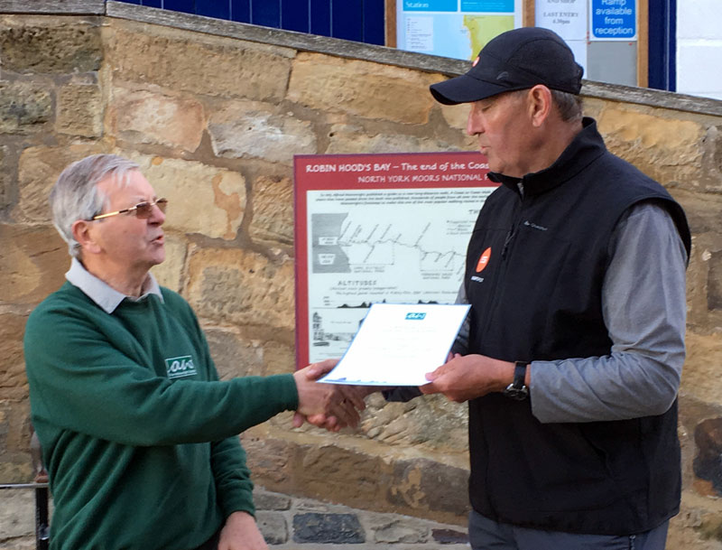 David Johnson presenting Graham Gooch with his completer’s certificate at the end of the Coast to Coast.